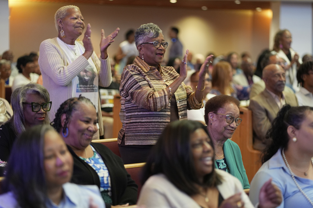 Saundra Powell, standing center, worships at St. James Church, where Democrat Rep. Emanuel Cleaver II was once pastor and is now facing an uphill reelection battle after the Missouri legislature redrew maps to to divide Clever's congressional district among three districts, Sunday, Sept. 7, 2025, in Kansas City, Mo. (AP Photo/Charlie Riedel)