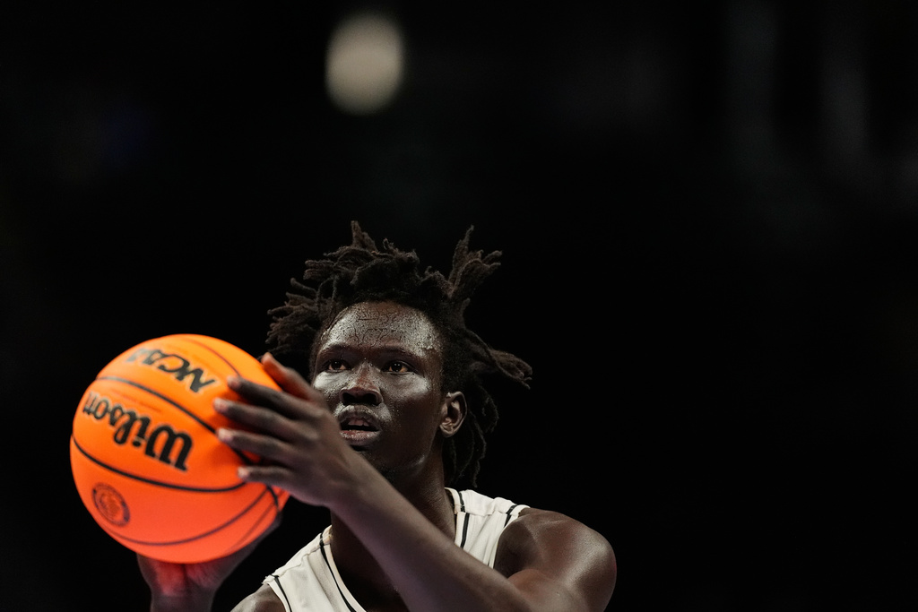UCF's John Bol shoots a free-throw during the second half of an NCAA college basketball game against Cincinnati in the second round of the Big 12 Conference tournament Wednesday, March 11, 2026, in Kansas City, Mo. (AP Photo/Charlie Riedel)