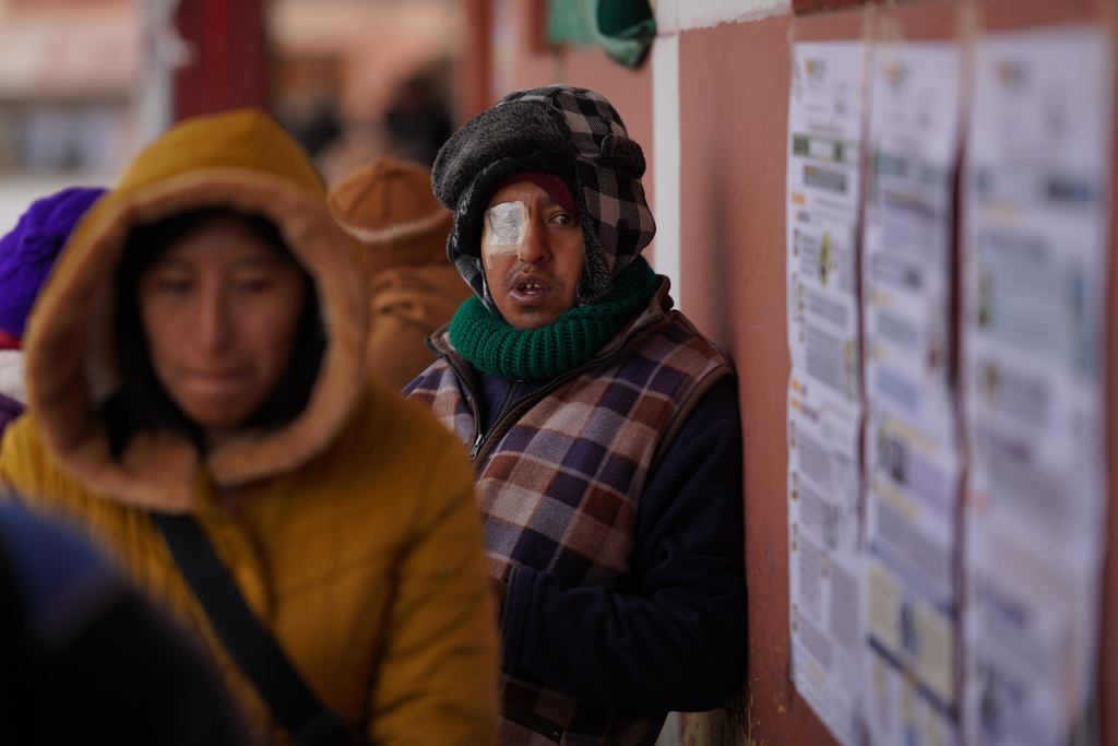 Voters queue at a polling station during presidential runoff election in El Alto, Bolivia, Sunday, Oct. 19, 2025. (AP Photo/Ivan Valencia)