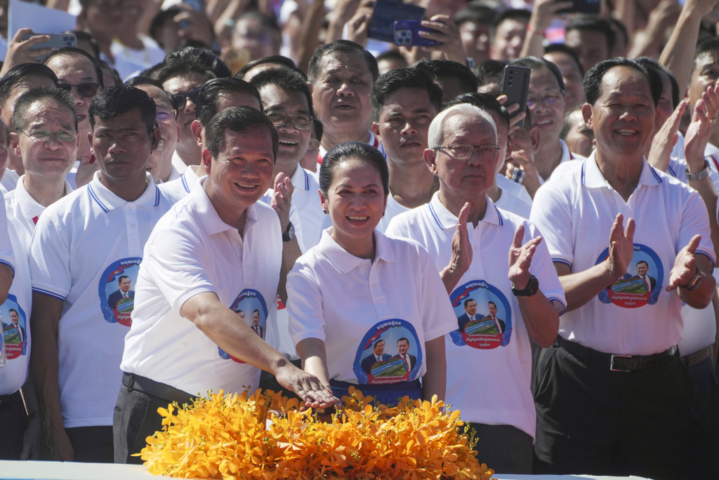 Cambodian Prime Minister Hun Manet, front left, accompanied by his wife Pich Chanmony, presses the button during a groundbreaking ceremony of China-funded Funan Techo canal that will connect the country&rsquo;s capital Phnom Penh with Kep province on the country's south coast, Prek Takeo village, Kendal province, Cambodia, Monday, Aug. 5, 2024. (AP Photo/Heng Sinith)