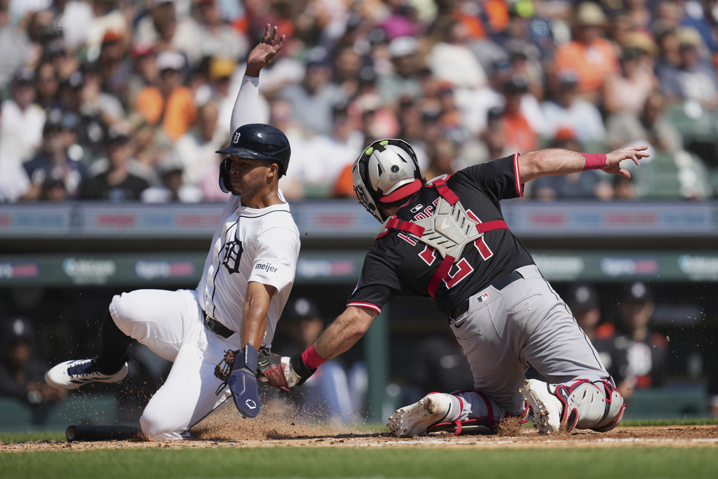 Cleveland Guardians catcher Austin Hedges (27) tags Detroit Tigers' Wenceel Pérez out at home plate during the second inning of a baseball game Thursday, Sept. 18, 2025, in Detroit. (AP Photo/Paul Sancya)