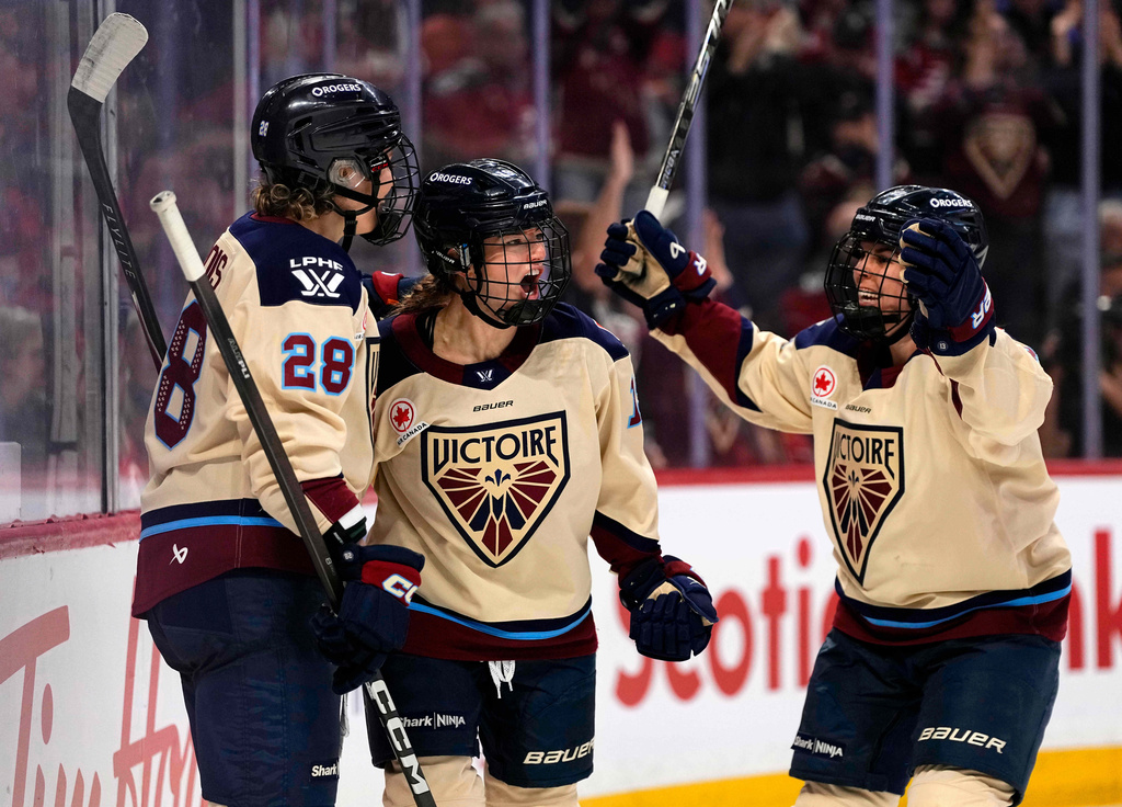 Montreal Victoire's Kaitlin Willoughby, center, celebrates after her goal against the Ottawa Charge with Catherine Dubois (28) and Alexandra Labelle, right, during second-period PWHL hockey game action in Ottawa, Ontario, Friday, April 3, 2026. (Justin Tang/The Canadian Press via AP)