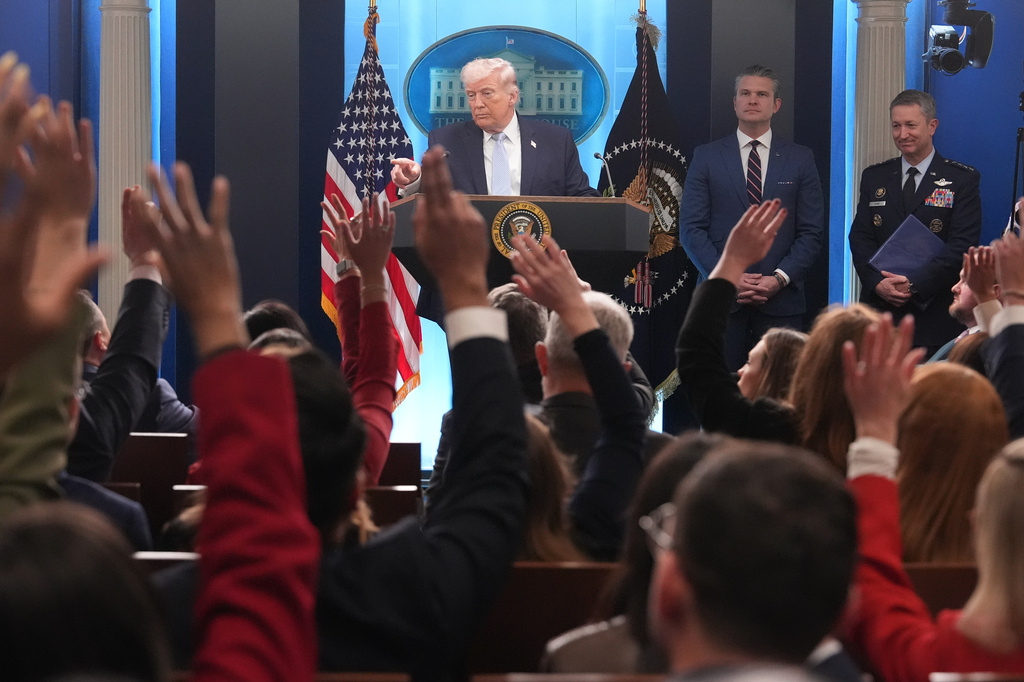 President Donald Trump speaks with reporters during a news conference in the James Brady Press Briefing Room at the White House, Monday, April 6, 2026, in Washington, as Defense Secretary Pete Hegseth and Chairman of the Joint Chiefs of Staff Gen. Dan Caine listen. (AP Photo/Mark Schiefelbein)