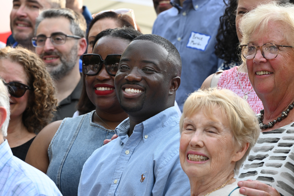 Adrian Boafo, center, a Maryland state delegate and candidate for U.S. Congress smiles for a photograph, which included all of U.S. Representative Steny Hoyer's staff over the years, at the "AmeriPac Bull Roast" Friday, June 12, 2026, in Mitchellville, Md. (AP Photo/Gail Burton)