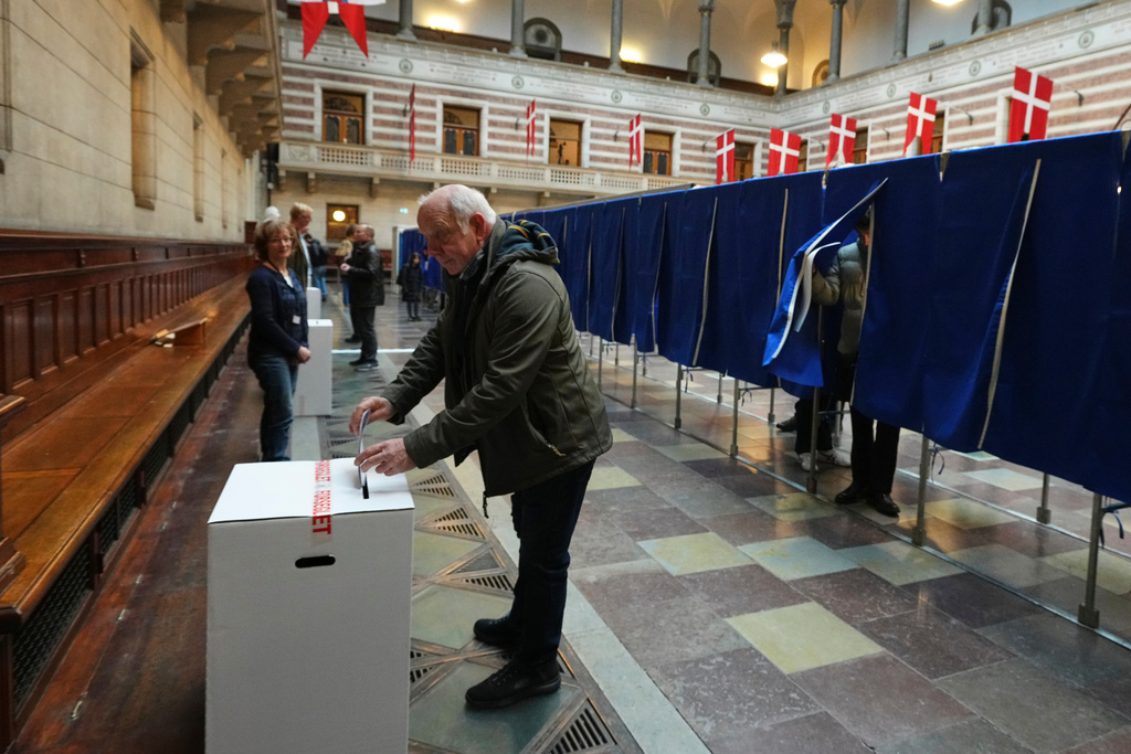 A man casts a ballot at a polling station at City Hall in Copenhagen, Denmark, on Tuesday, March 24, 2026, during the general election. (AP Photo/Sergei Grits)