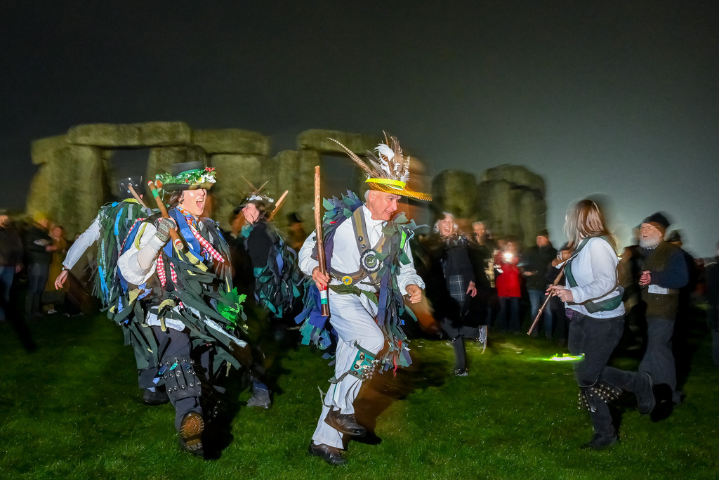 People celebrate the Winter Solstice sunrise celebrations at Stonehenge, a world-famous prehistoric monument on Salisbury Plain, England, Sunday, Dec. 21, 2025.(AP Photo/Anthony Upton)