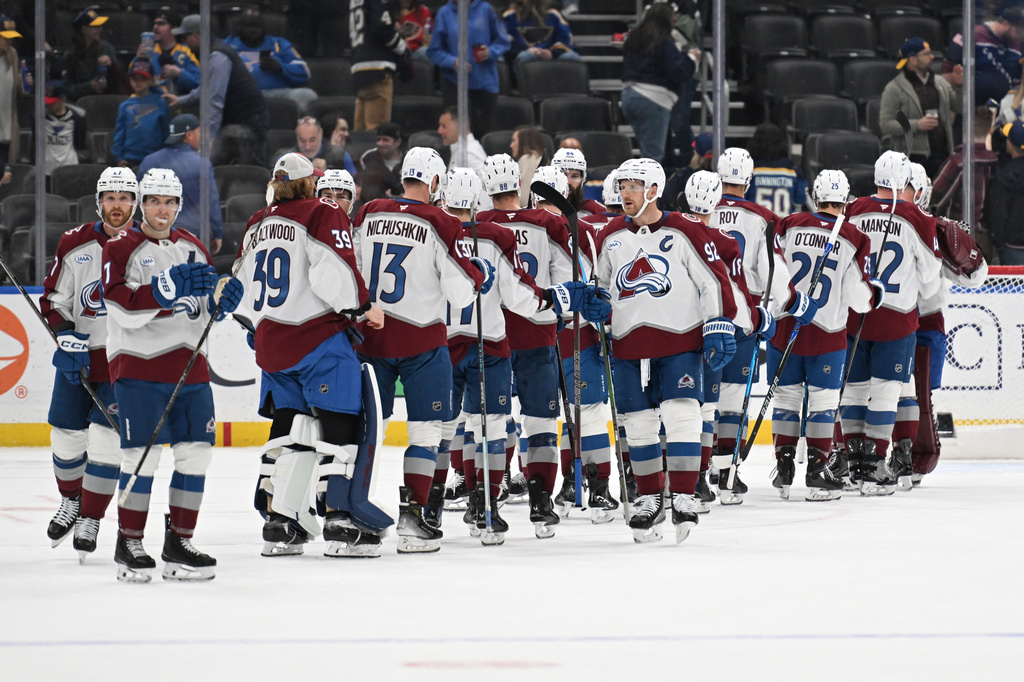 The Colorado Avalanche celebrate after beating the St. Louis Blues in an NHL hockey game, Tuesday, April 7, 2026, in St. Louis. (AP Photo/Joe Puetz)