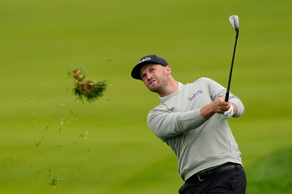 Wyndham Clark hits from the rough on the 11th hole during the first round of the PGA Championship golf tournament practice round at Aronimink Golf Club, Thursday, May 14, 2026, in Newtown Square, PA. (AP Photo/Carolyn Kaster)