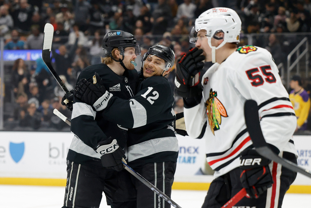 Los Angeles Kings left wing Warren Foegele (37) is greeted by Los Angeles Kings left wing Trevor Moore (12) after scoring during the second period of an NHL hockey game Saturday, Dec. 6, 2025, in Los Angeles. (AP Photo/Caroline Brehman)