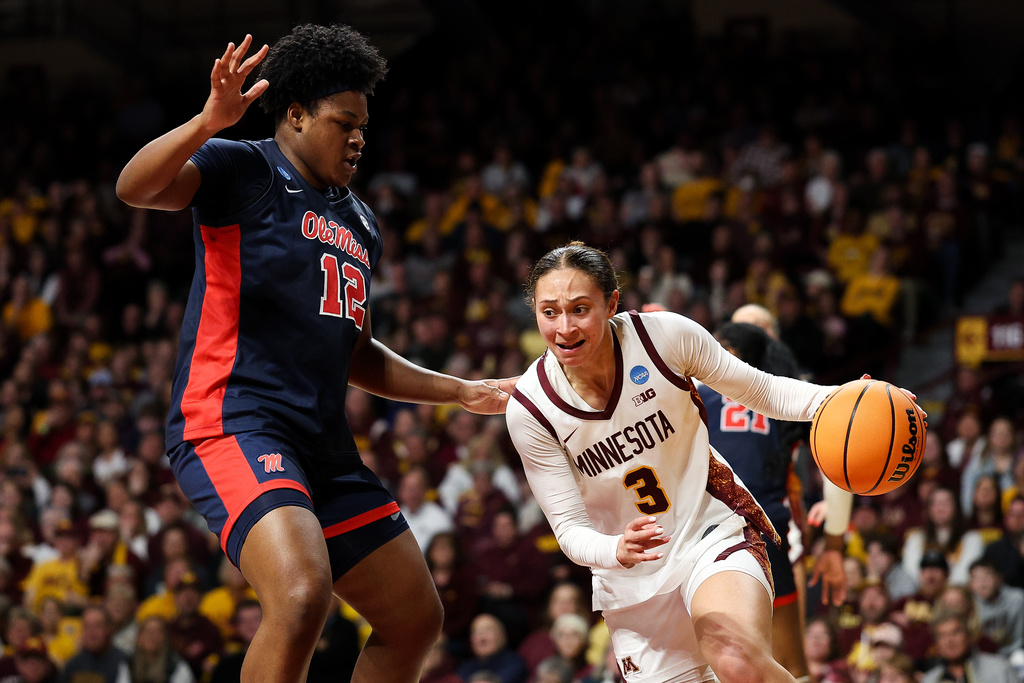 Minnesota guard Amaya Battle, right, works around Mississippi forward Christeen Iwuala (12) during the second half in the second round of the NCAA college basketball tournament, Sunday, March 22, 2026, in Minneapolis. (AP Photo/Matt Krohn)