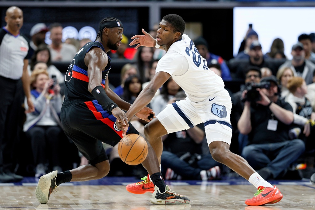 Memphis Grizzlies forward Cedric Coward (23) steals the ball from Detroit Pistons guard Caris LeVert (8) during the first half of an NBA basketball game Friday, March 13, 2026, in Detroit. (AP Photo/Duane Burleson)