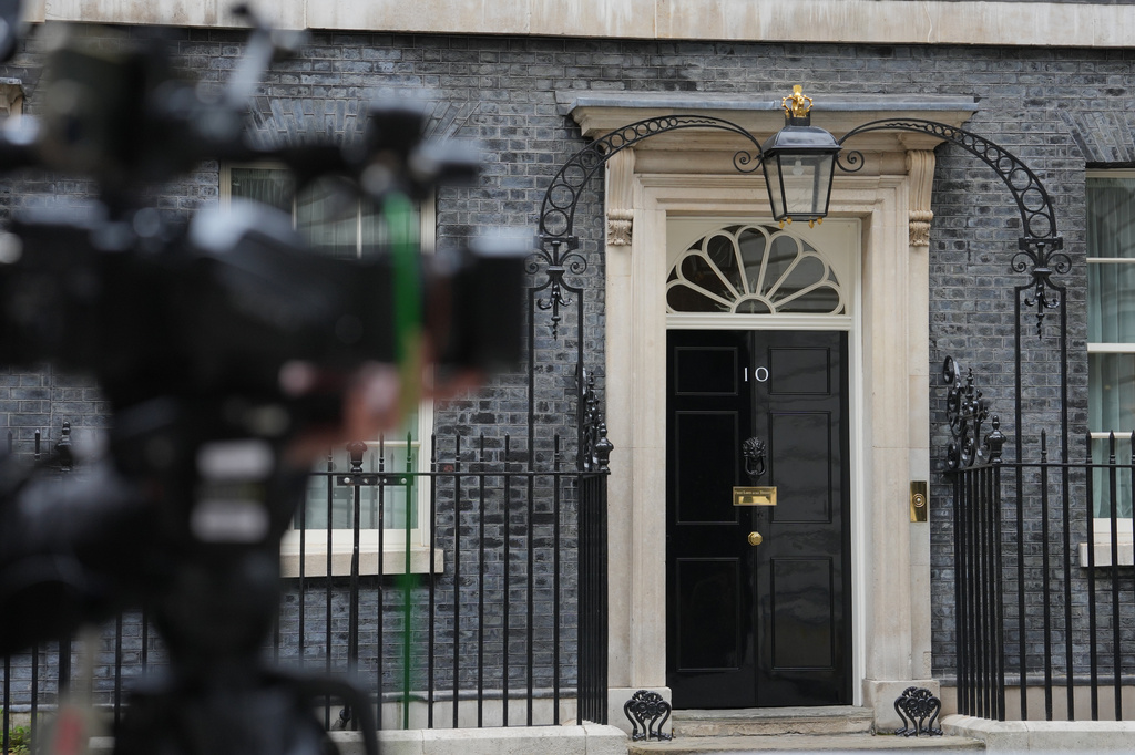 A television camera looks down Downing Street, as media wait in the street, following the resignation of two Defense ministers over funding of the British armed forces, in London, Friday, June 12, 2026. (AP Photo/Kin Cheung)