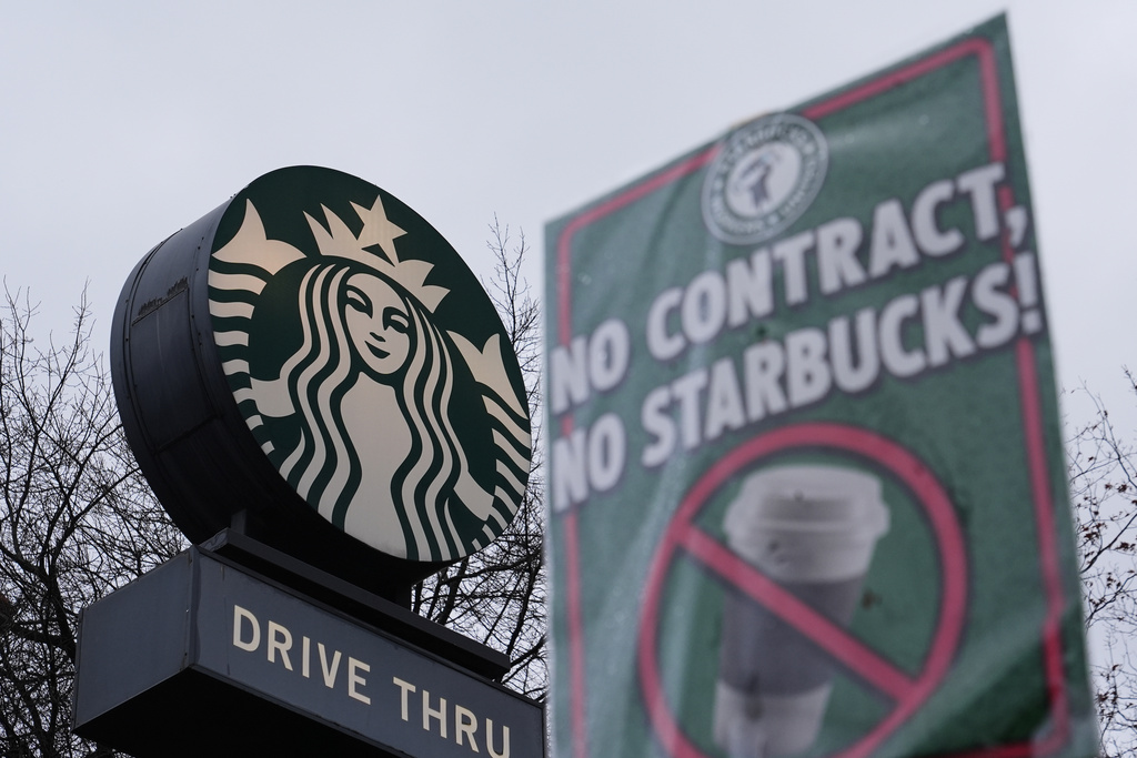 The Starbucks logo is seen as workers strike outside a store Thursday, Nov. 13, 2025, in Seattle. (AP Photo/Lindsey Wasson)