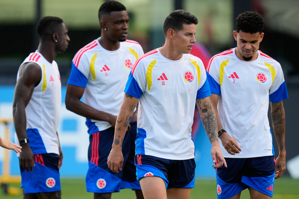 Colombia's James Rodriguez (10) and Luis Diaz (7) walk with teammates during a training session in Fort Lauderdale, Fla., Friday, June 26, 2026, on the eve of the team's Group K World Cup soccer match against Portugal. (AP Photo/Rebecca Blackwell)