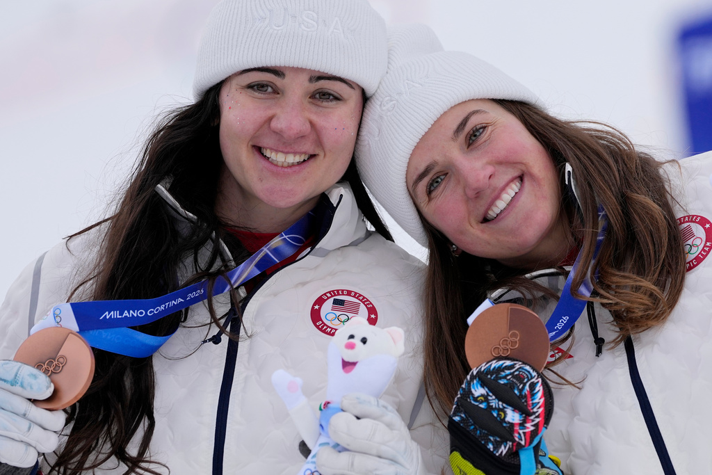 United States' Jacqueline Wiles, left, and teammate United States' Paula Moltzan show their bronze medals in an alpine ski, women's team combined race, at the 2026 Winter Olympics, in Cortina d'Ampezzo, Italy, Tuesday, Feb. 10, 2026. (AP Photo/Andy Wong)