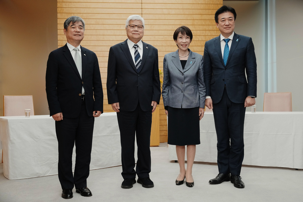 Japan's Prime Minister Sanae Takaichi, second right, and Chief Cabinet Secretary Minoru Kihara, right, pose for a photo with Taiwan Semiconductor Manufacturing Company's Chairman C.C. Wei, second left, and Vice President Jonathan Lee at the beginning of their meeting at the prime minister's office in Tokyo, Thursday, Feb. 5, 2026. (Kazuhiro Nogi/Pool Photo via AP)