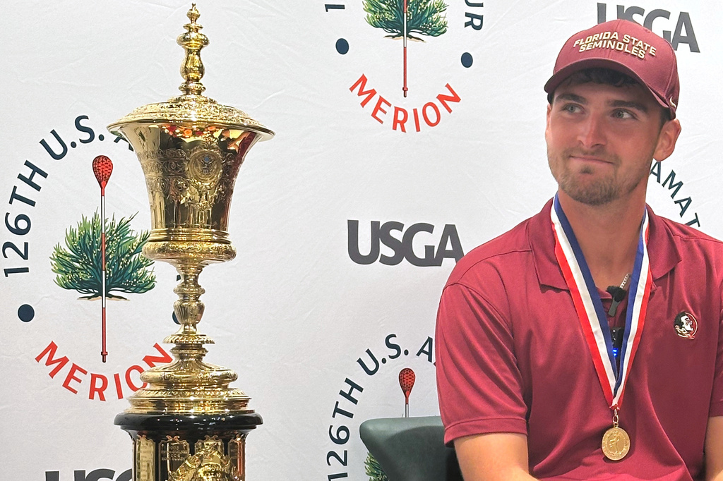 Jack Whaley admires his US Amateur golf championship trophy Sunday, Aug. 16, 2026, at Merion Golf Club in Ardmore, Pa. (AP Photo/Dan Gelston)