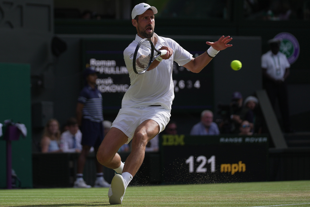 Novak Djokovic of Serbia returns the ball to Roman Saffiullin of Russia in their fourth round men's singles match at the Wimbledon Tennis Championships in London, Sunday, July 5, 2026. (AP Photo/Brian Inganga)