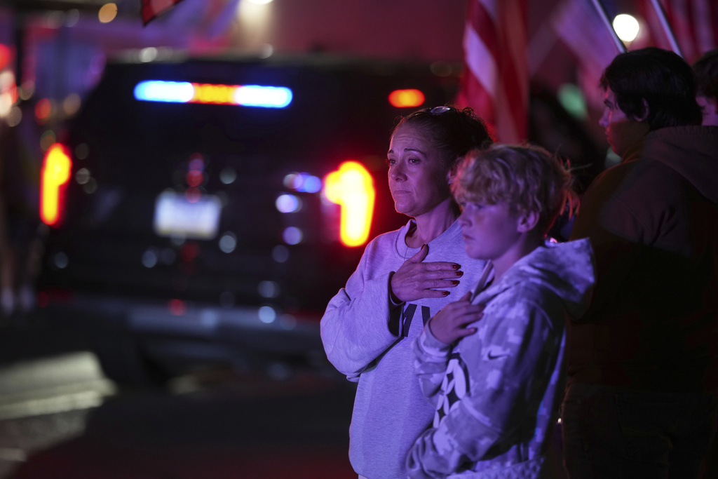 Attendees look on during a procession Wednesday, Sept. 17, 2025, in Spring Grove, Pa., after multiple police officers were shot and killed. (AP Photo/Matt Slocum)