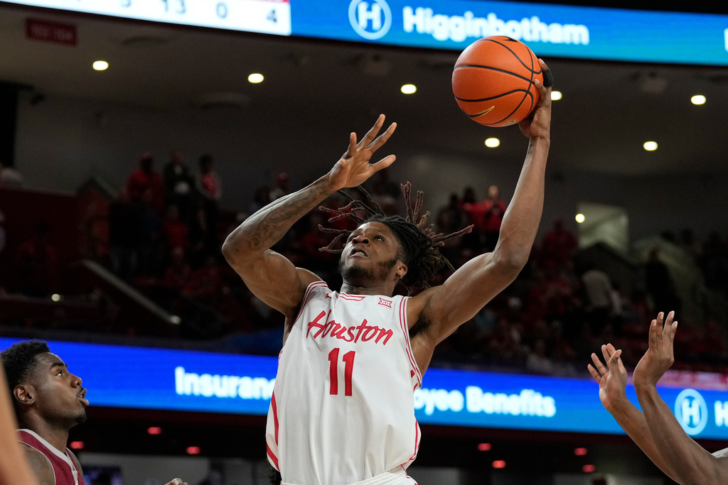 Houston forward Joseph Tugler (11) drives to the basket during the second half of an NCAA college basketball game against Rider, Thursday, Nov. 20, 2025, in Houston. (AP Photo/Kevin M. Cox)