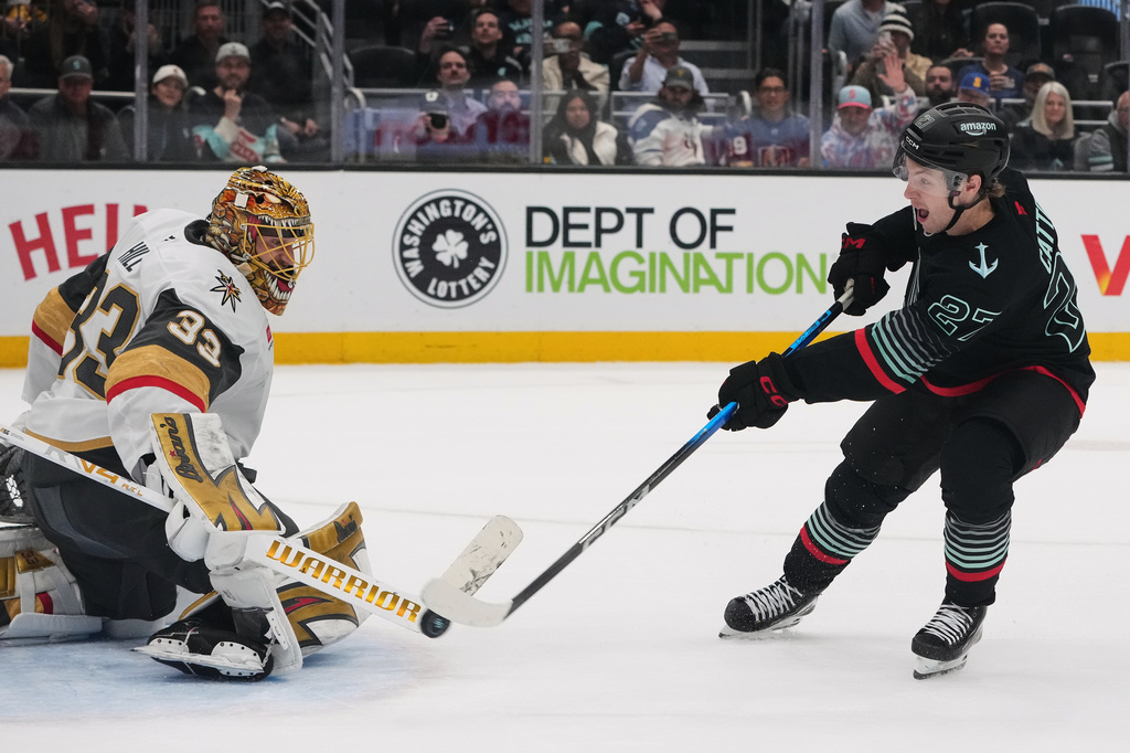 Seattle Kraken center Berkly Catton makes the winning shot against Vegas Golden Knights goaltender Adin Hill during a shootout in an NHL hockey game Thursday, April 9, 2026, in Seattle. (AP Photo/Lindsey Wasson)