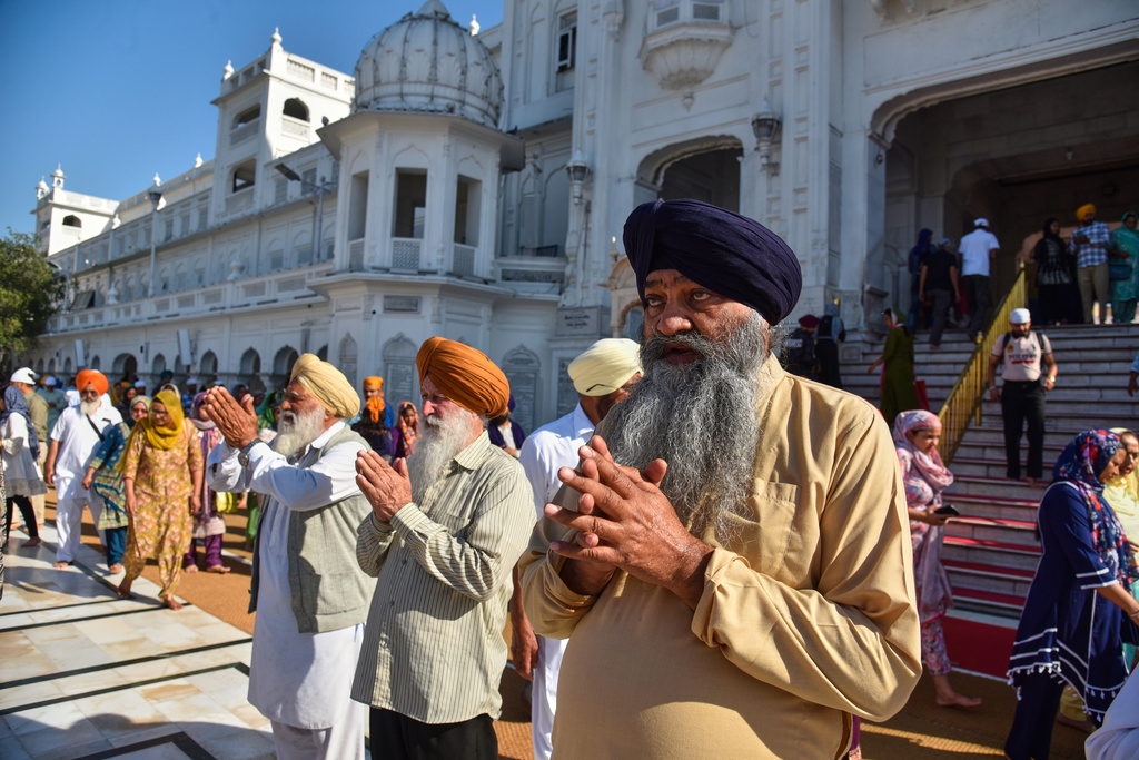 Sikh devotees arrive to pay their respects at the Golden Temple, Sikhism's holiest shrine, on Vaisakhi, a spring harvest festival for Sikhs and Hindus, in Amritsar, India, Tuesday, April 14, 2026. (AP Photo/Prabhjot Gill)