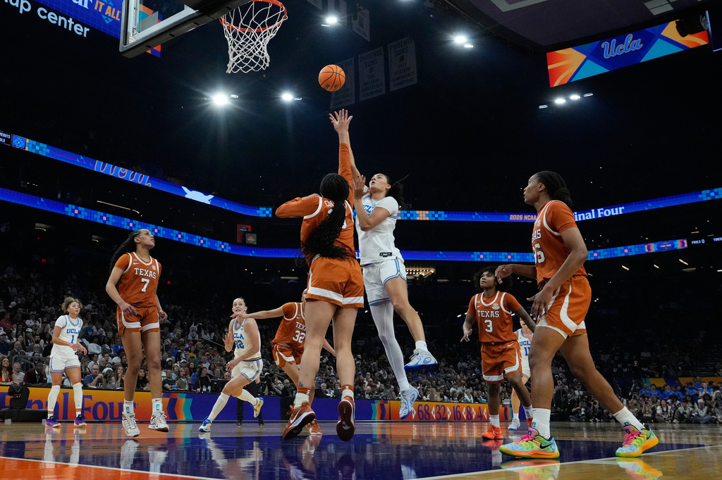UCLA center Lauren Betts (51) shoots against Texas during the first half of a women's NCAA college basketball tournament semifinal game at the Final Four, Friday, April 3, 2026, in Phoenix. (AP Photo/Ross D. Franklin)