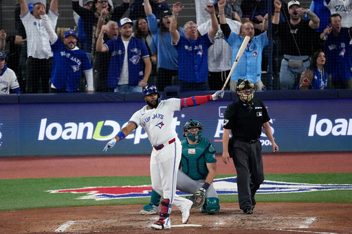 Toronto Blue Jays' Vladimir Guerrero Jr. watches his solo home run take flight against the Seattle Mariners during the fifth inning in Game 6 of baseball's American League Championship Series, Sunday, Oct. 19, 2025, in Toronto. (AP Photo/David J. Phillip) Toronto Blue Jays' Vladimir Guerrero Jr. watches his solo home run take flight against the Seattle Mariners during the fifth inning in Game 6 of baseball's American League Championship Series, Sunday, Oct. 19, 2025, in Toronto. (AP Photo/David J. Phillip)