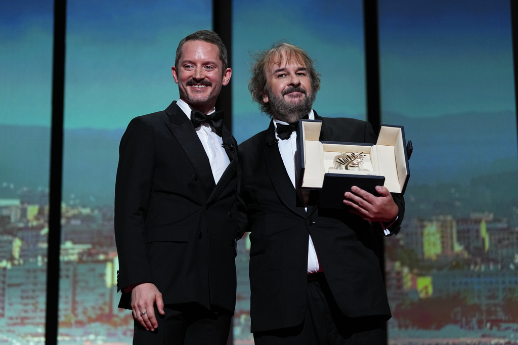 Elijah Wood, from left, and director Peter Jackson, recipient of the honorary Palme d'Or, pose for photographers during the opening ceremony of the 79th international film festival, Cannes, southern France, Tuesday, May 12, 2026. (Photo by Scott A Garfitt/Invision/AP)