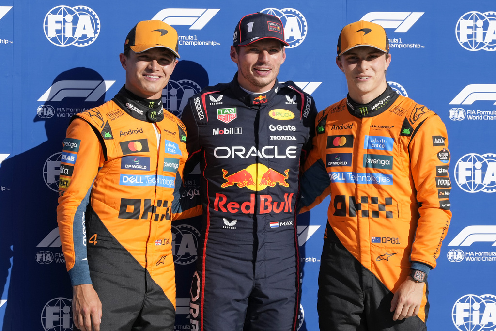 Red Bull driver Max Verstappen of the Netherlands, centre, celebrates his pole position with McLaren driver Lando Norris of Britain, left, and McLaren driver Oscar Piastri of Australia after the qualifying session ahead of the Italian Grand Prix at the Monza racetrack in Monza, Italy, Saturday, Sept. 6, 2025. (AP Photo/Luca Bruno)
