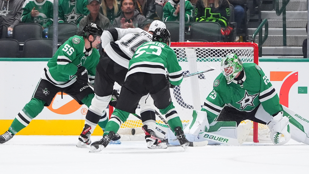 Los Angeles Kings right wing Corey Perry (10) scores a goal against Dallas Stars defenders Thomas Harley (55), Wyatt Johnston (53) and goaltender Jake Oettinger (29) during the first period of an NHL hockey game Thursday, Oct. 23, 2025, in Dallas. (AP Photo/LM Otero)