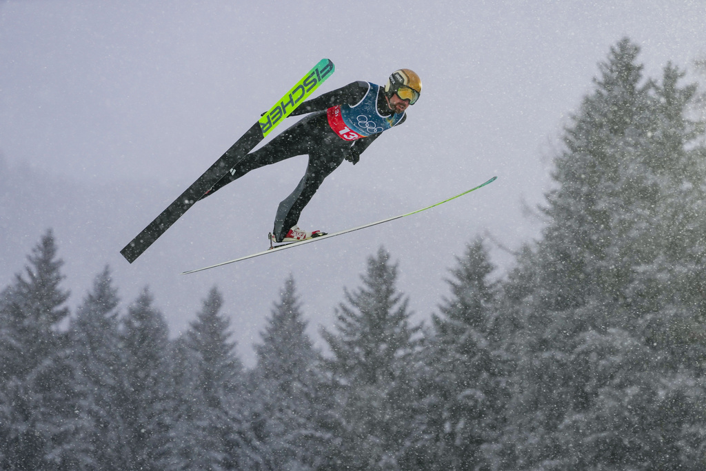 Johannes Rydzek, of Germany, soars through the air during the nordic combined team sprint at the 2026 Winter Olympics, in Predazzo, Italy, Thursday, Feb. 19, 2026. (AP Photo/Evgeniy Maloletka)