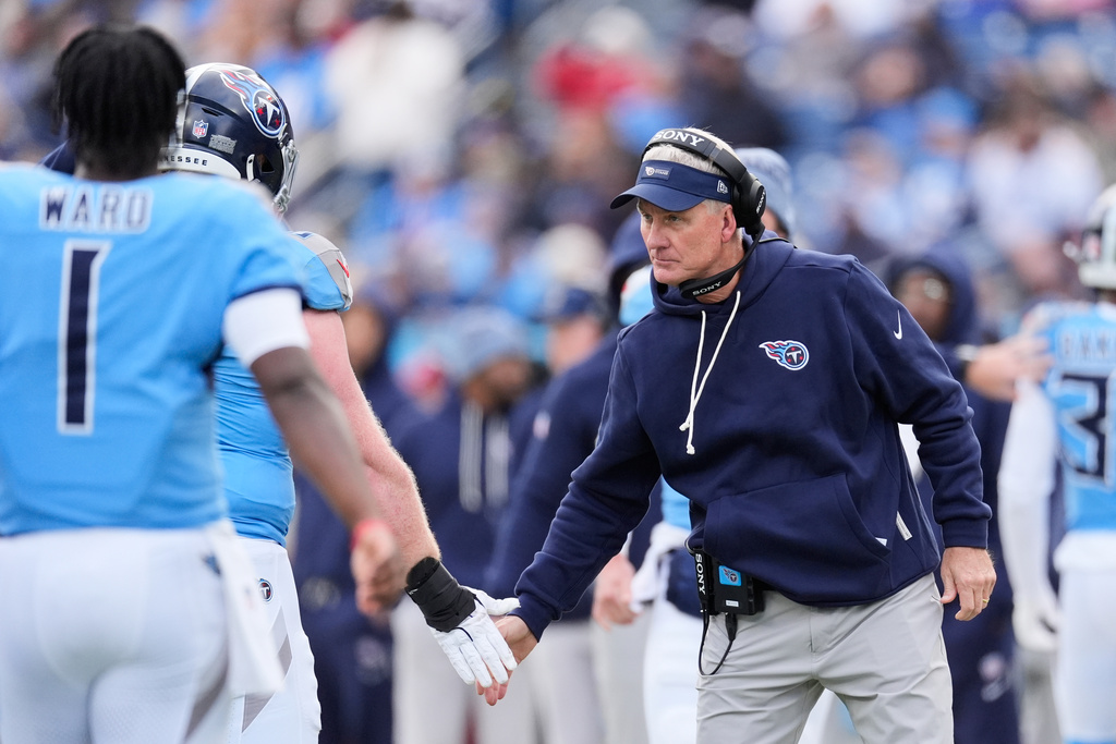 Tennessee Titans head coach Mike McCoy shakes hands with players walking off the field during the first half of an NFL football game against the Los Angeles Chargers, Sunday, Nov. 2, 2025, in Nashville, Tenn. (AP Photo/George Walker IV)