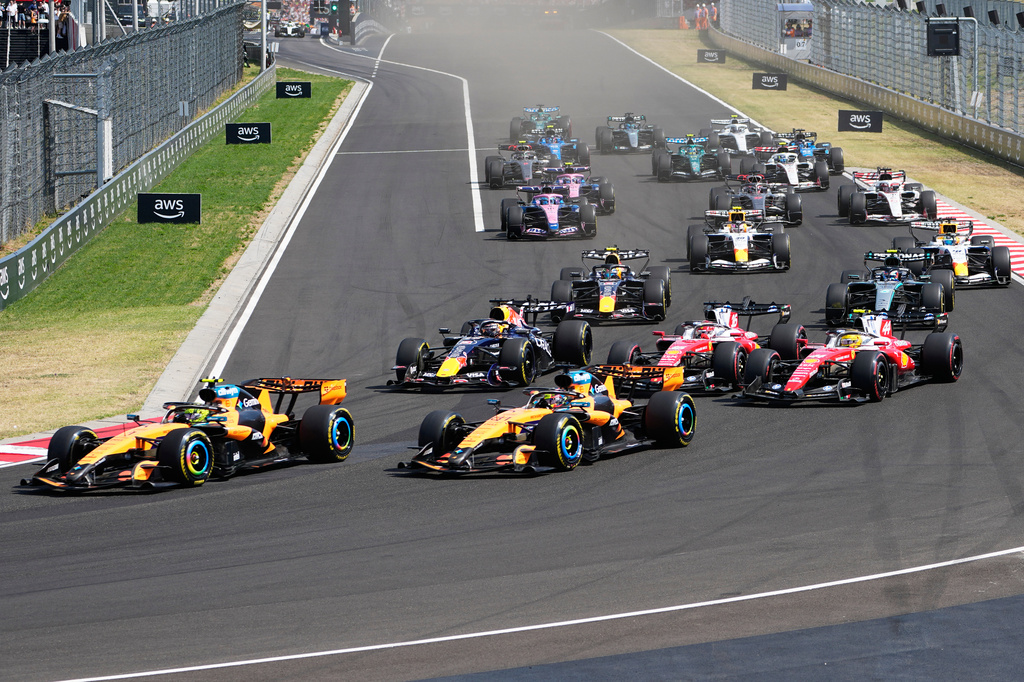 McLaren driver Lando Norris of Britain, left, leads the field after the start during the Formula One Hungarian Grand Prix auto race, at the Hungaroring racetrack in Mogyorod, near Budapest, Hungary, Sunday, July 26, 2026. (AP Photo/Darko Bandic)