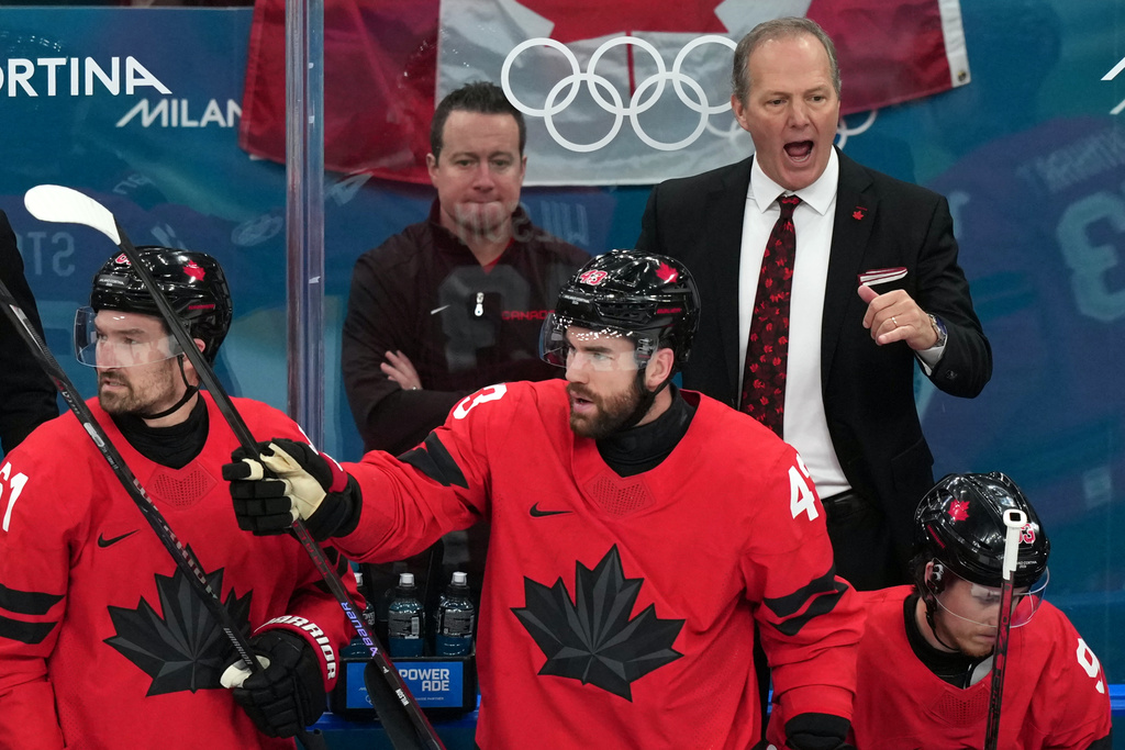 Canada head coach Jon Cooper, top right, directs his players during the first period of the men's ice hockey gold medal game against the United States at the 2026 Winter Olympics in Milan, Italy, Sunday, Feb. 22, 2026. (AP Photo/Carolyn Kaster)