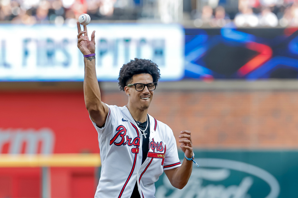 Atlanta Hawks basketball player Jalen Johnson throws out the ceremonial first pitch before the Atlanta Braves host the San Francisco Giants in a baseball game, Wednesday, June 17, 2026, in Atlanta. (AP Photo/Erik S. Lesser)