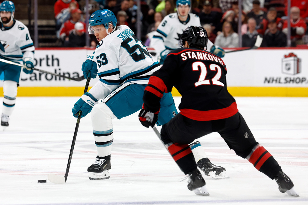 San Jose Sharks' Jeff Skinner (53) controls the puck in front of Carolina Hurricanes' Logan Stankoven (22) during the first period of an NHL hockey game in Raleigh, N.C., Sunday, Dec. 7, 2025. (AP Photo/Karl DeBlaker)