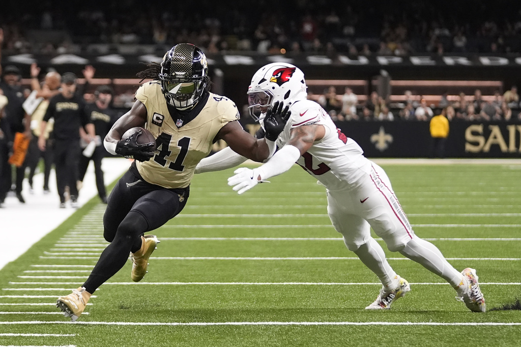 New Orleans Saints running back Alvin Kamara (41) gets past Arizona Cardinals safety Dadrion Taylor-Demerson for a touchdown during the first half of an NFL football game Sunday, Sept. 7, 2025, in New Orleans. (AP Photo/Gerald Herbert )