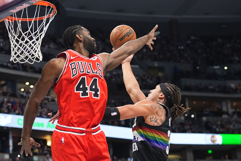 Denver Nuggets forward Aaron Gordon, right, drives to the basket as Chicago Bulls forward Patrick Williams (44) defends in the first half of an NBA basketball game Monday, Nov. 17, 2025, in Denver. (AP Photo/David Zalubowski)