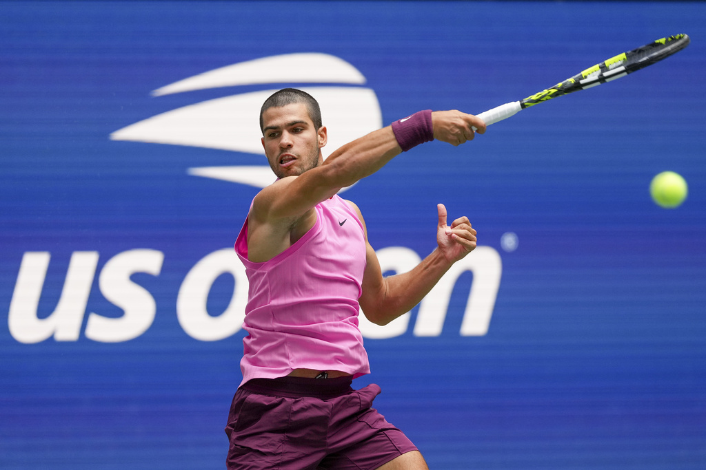 Carlos Alcaraz, of Spain, returns a shot to Jiri Lehecka, of the Czech Republic, during the quarterfinal round of the U.S. Open tennis championships, Tuesday, Sept. 2, 2025, in New York. (AP Photo/Kirsty Wigglesworth)