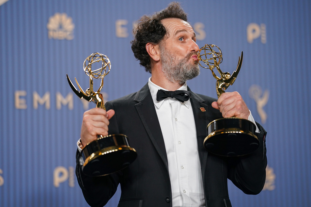 Matthew Rhys poses in the press room with the awards for outstanding lead actor in a limited or anthology series or movie for "The Beast In Me," and outstanding lead actor in a comedy series for "Widow's Bay" during the 78th Emmy Awards on Monday, Sept. 14, 2026, at the JW Marriott in Los Angeles. (Photo by Richard Shotwell/Invision/AP)