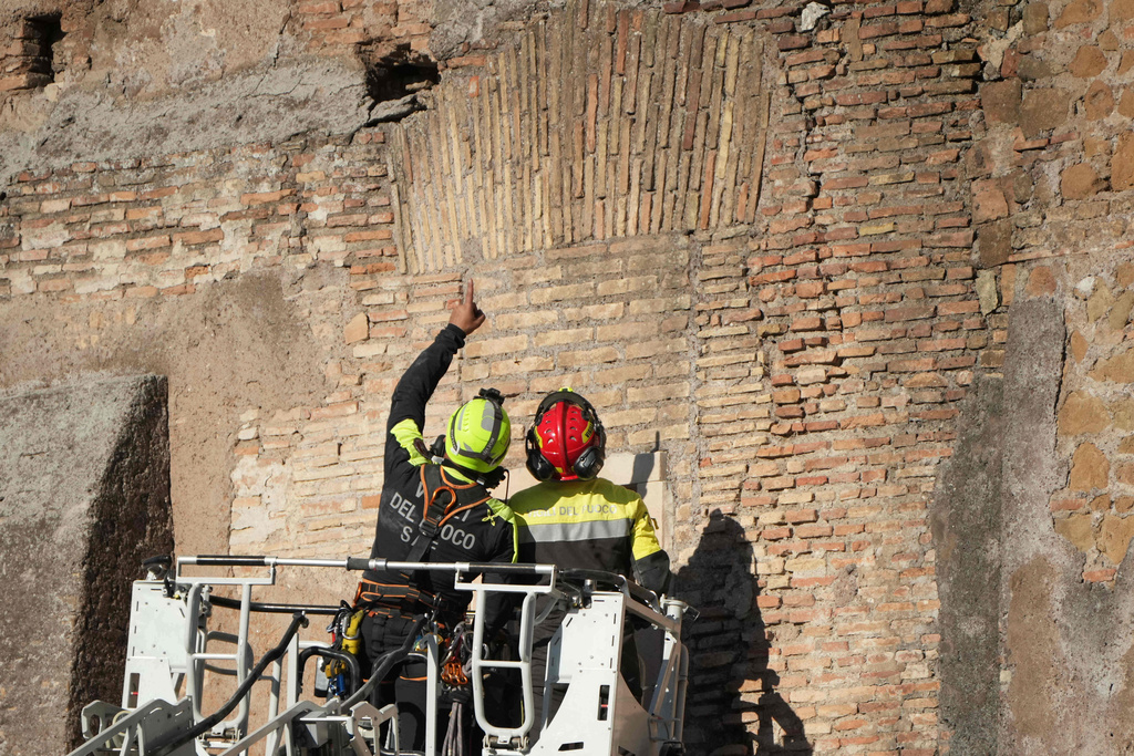 Firefighters work on a medieval tower Torre dei Conti near the Roman Forum after it had partially collapsed during renovation works, meters away from the Colosseum in Rome, Monday, Nov. 3, 2025. (AP Photo/Andrew Medichini)