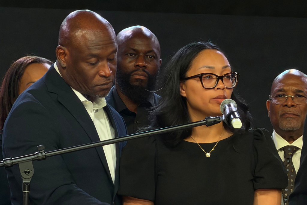 In this photo taken with a smartphone, Nolan Wells' mother, Christine Wonsley, speaks at a news conference in Stonecrest, Ga., Thursday, Sept. 22, 2026, accompanied by Wells' father, Elmore Wonsley. (AP Photo/Emilie Megnien)