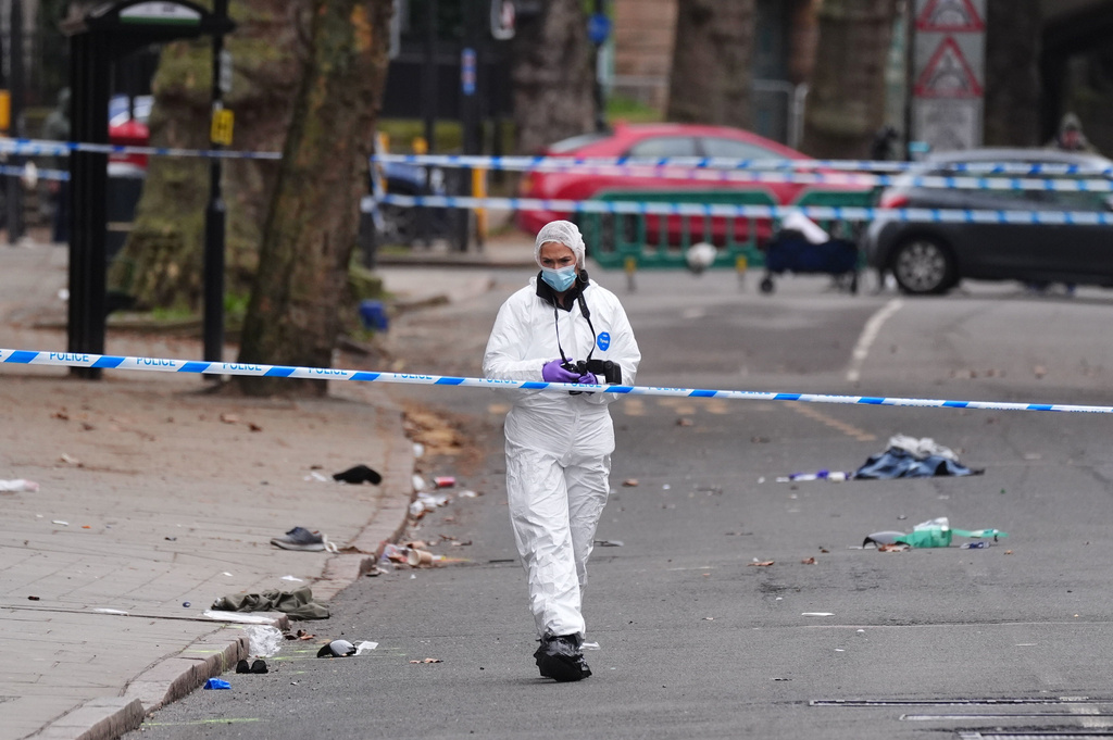 A forensic investigator works on the scene in Friar Gate, Derby, Sunday March 29, 2026, where a number of people had been injured, some of them seriously, after being hit by a car in the city centre on Saturday night. (Jacob King/PA via AP)