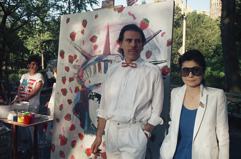 FILE - Artist Peter Max, left, and Yoko Ono pose together at Central Park with a Statue of Liberty-Strawberry Fields mural on July 4, 1986, in New York. (AP Photo/David Bookstaver, File)