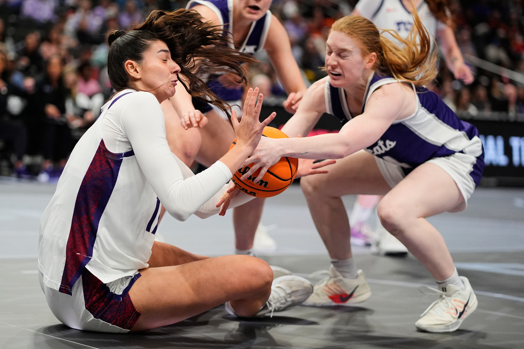 Kansas State's Tess Heal, right, and TCU's Clara Silva battle for the ball during first half of an NCAA college basketball game in the semifinals of the Big 12 Conference tournament Saturday, March 7, 2026, in Kansas City, Mo. (AP Photo/Charlie Riedel)