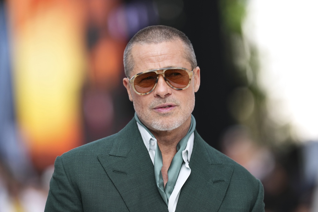 FILE - Brad Pitt poses for photographers upon arrival at the premiere of the film 'F1 The Movie' on Monday, June 23, 2025, in London. (Photo by Scott A Garfitt/Invision/AP, file)