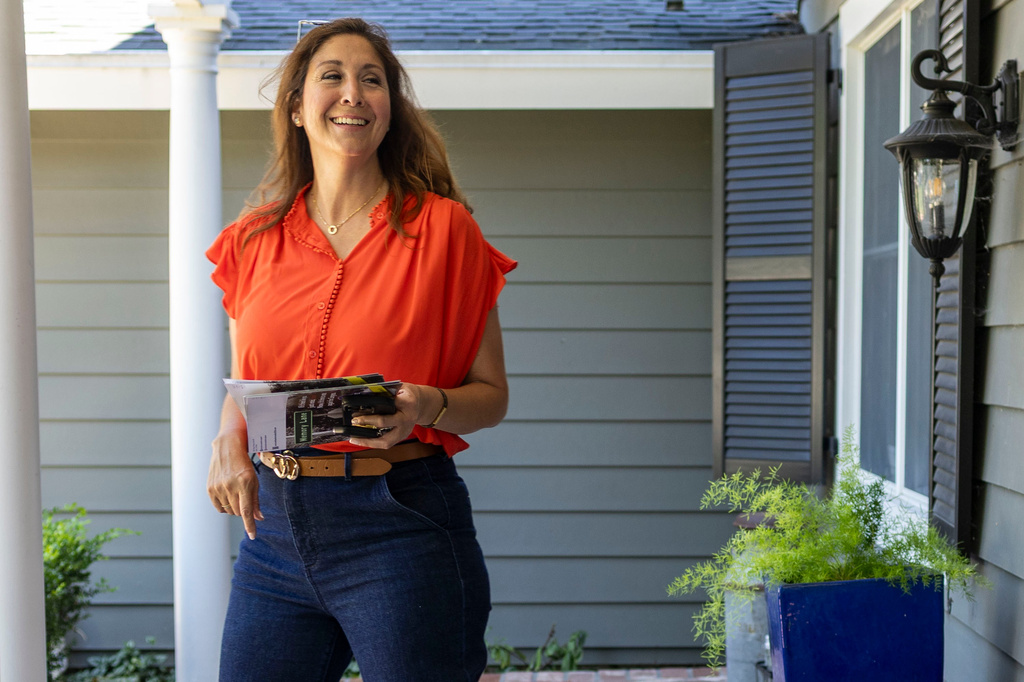 Melissa Hernandez, a Democratic candidate for Congress in California's 14th district, knocks on doors on Sunday, June 14, 2026 in Pleasanton, Calif. (AP Photo/Annie Barker )