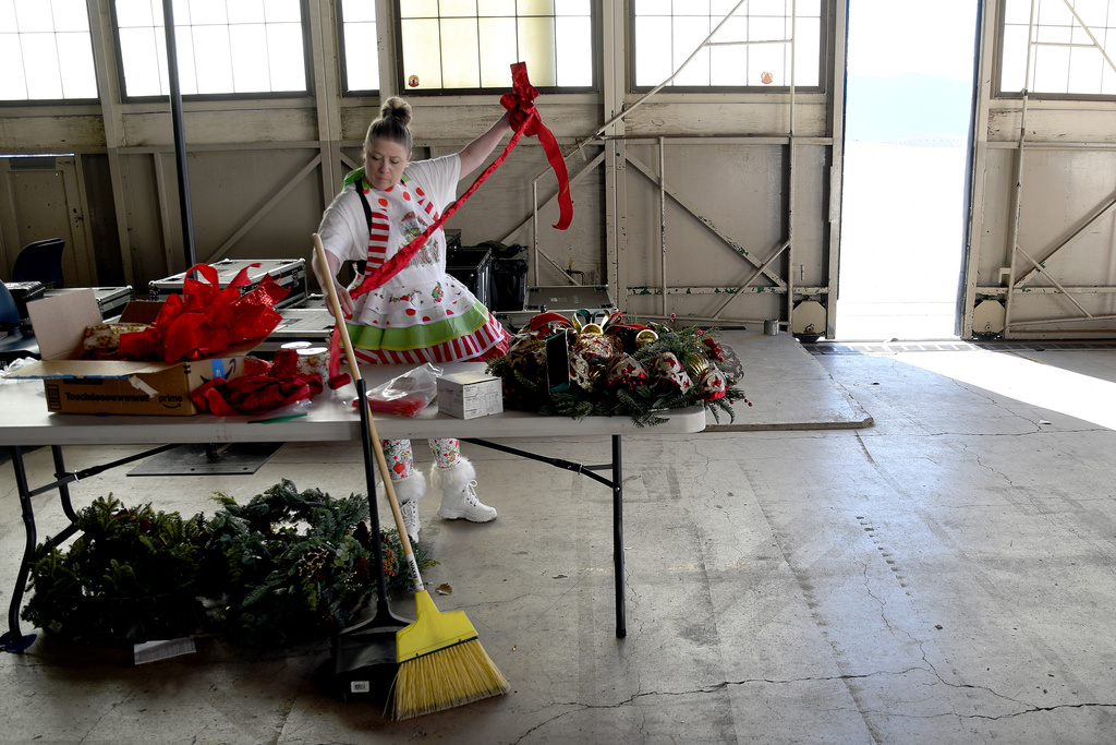 Designer Michelle Reid prepares holiday decorations inside a hangar at Peterson Space Force Base in Colorado Springs, Colo., on Thursday, Dec. 18, 2025 in advance of the annual NORAD Tracks Santa Operation, at the North American Aerospace Defense Command. (AP Photo/Thomas Peipert)