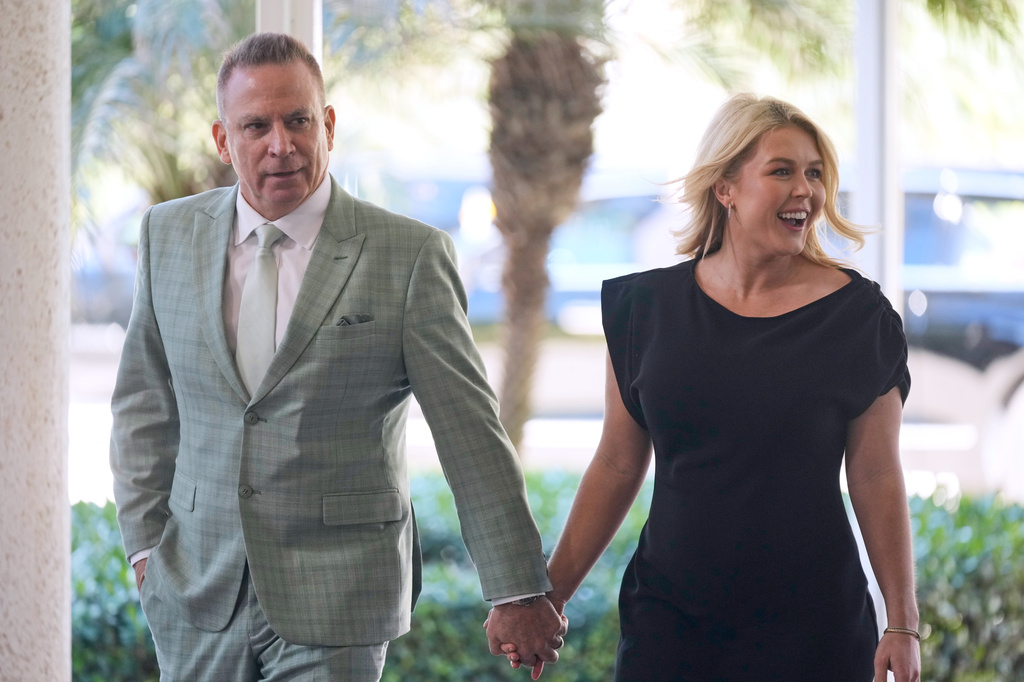 FILE - White House press secretary Karoline Leavitt and her husband Nicholas Riccio arrive at The Mar-a-Lago Club, Feb. 1, 2026, in Palm Beach, Fla., to attend the wedding of White House deputy chief of staff Dan Scavino and Erin Elmore, the director of Art in Embassies at the U.S. Department of State. (AP Photo/Mark Schiefelbein, File)